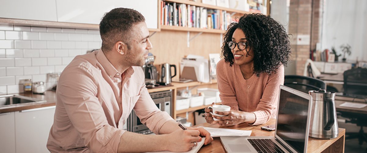 Couple in the kitchen with spreadsheets